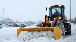 A snowplow clears a parking lot during a storm in Bemidji, Minnesota. A snowplow clears a parking lot during a storm in Bemidji, Minnesota.