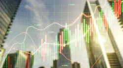 Stock charts overlaid on top of blurred background image of skyscrapers.
