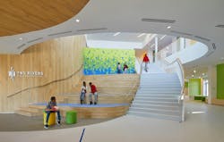 Custom-cut PET tiles in vivid colors combine to create a colorful wall installation in this student gathering space at Two Rivers Middle School in Washington, D.C. The playful pattern helps draw students into the school. Custom-cut PET tiles in vivid colors combine to create a colorful wall installation in this student gathering space at Two Rivers Middle School in Washington, D.C. The playful pattern helps draw students into the school.
