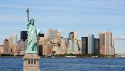 The Statue of Liberty stands against the New York City skyline. The Statue of Liberty stands against the New York City skyline.