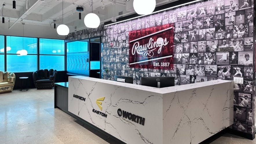 This collage wall in the lobby features Rawlings advisory players inducted into the Baseball Hall of Fame, including Mickey Mantle and Willie Mays.