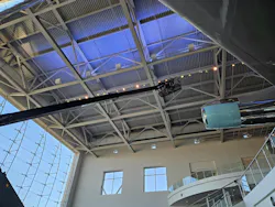 A Ronald Reagan Presidential Library facilities team member uses a lift to complete the Lotus lamp change above the Air Force One Pavilion.